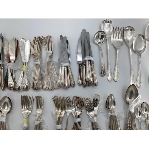 54 - A large collection of plated flatware and kitchen utensils