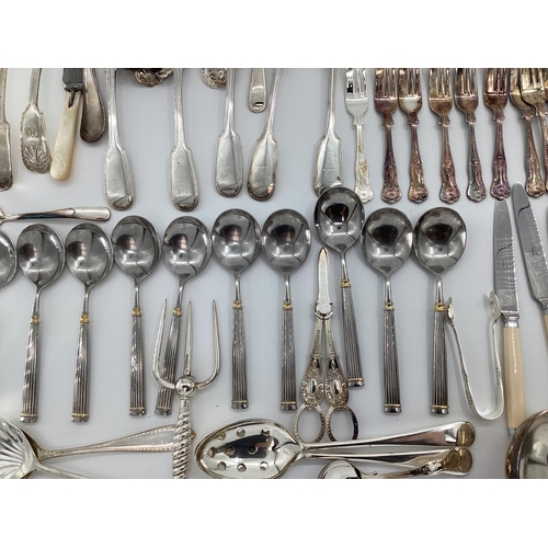 54 - A large collection of plated flatware and kitchen utensils