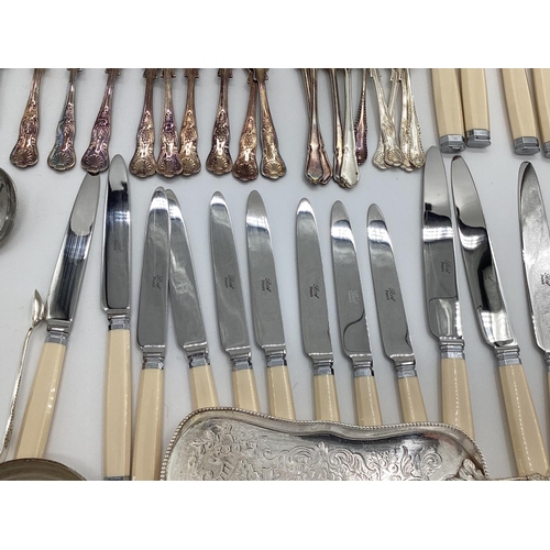 54 - A large collection of plated flatware and kitchen utensils