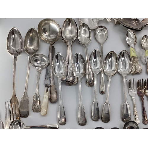 54 - A large collection of plated flatware and kitchen utensils