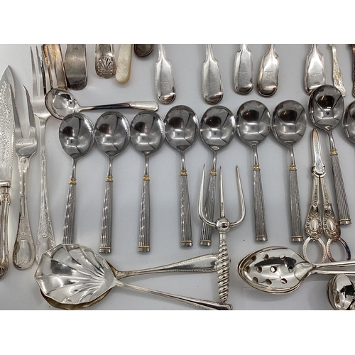 54 - A large collection of plated flatware and kitchen utensils