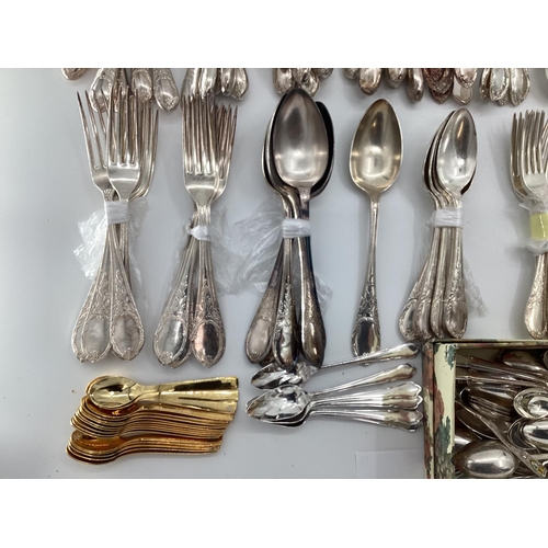 54 - A large collection of plated flatware and kitchen utensils