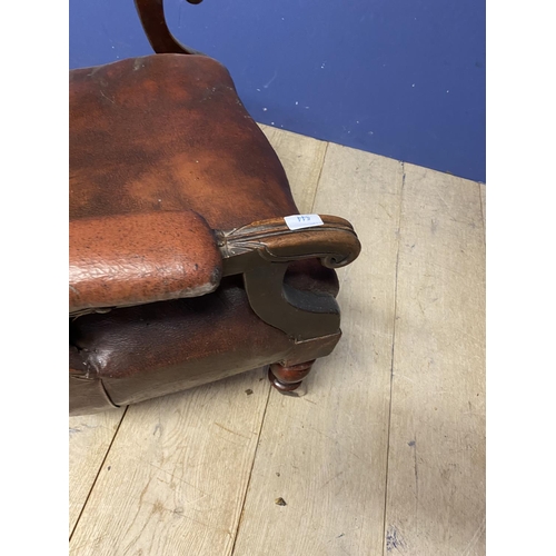 544 - Victorian button back fireside library chair with original rexine or leatheretteupholstery, on turne... 