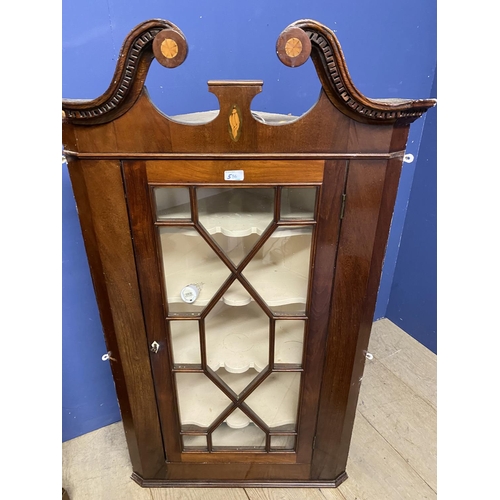 556 - A corner display cabinet with bow front glazed door and key