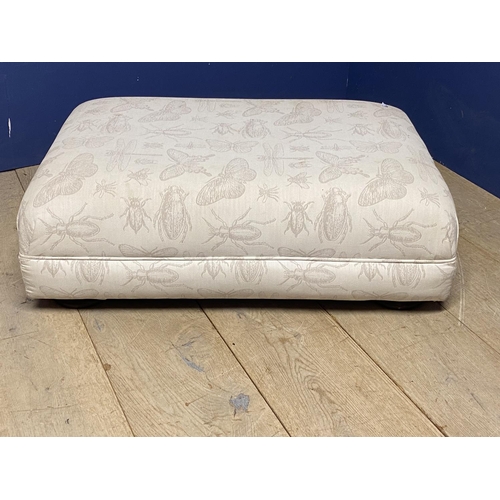 566 - A small square foot stool, upholstered in a cream insect patterned fabric, and a similar smaller lon... 