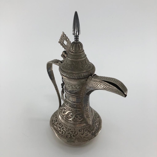 57 - An Indian /Omani style unmarked white metal coffee pot with floral decoration 503g, 25cm H