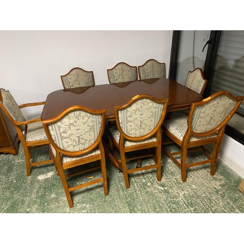 577 - A modern reproduction yew suite of table (with extension), 6 chairs and 2 carvers, and sideboard