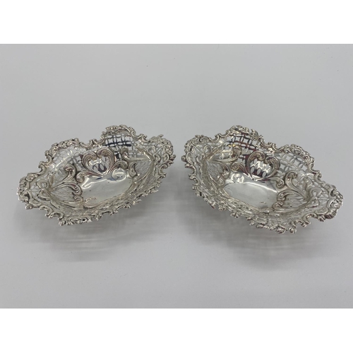 59 - A pair of sterling silver pierced oval dishes, and a silver topped glass dressing table item silver ... 