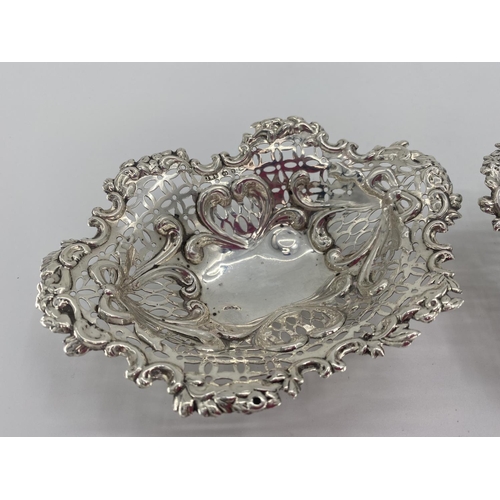 59 - A pair of sterling silver pierced oval dishes, and a silver topped glass dressing table item silver ... 