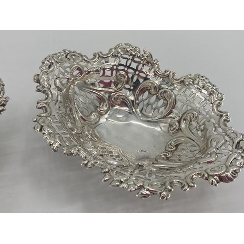 59 - A pair of sterling silver pierced oval dishes, and a silver topped glass dressing table item silver ... 