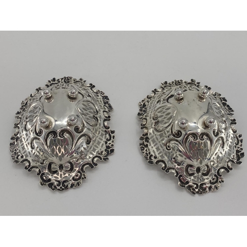 59 - A pair of sterling silver pierced oval dishes, and a silver topped glass dressing table item silver ... 