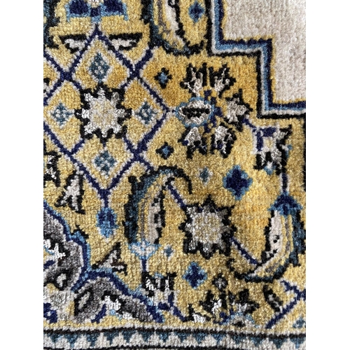 648 - A Qum wool rug, cream and blue ground, 130 x 77cm