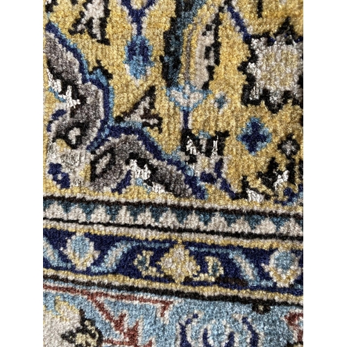 648 - A Qum wool rug, cream and blue ground, 130 x 77cm