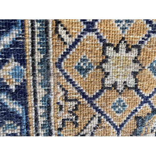 648 - A Qum wool rug, cream and blue ground, 130 x 77cm