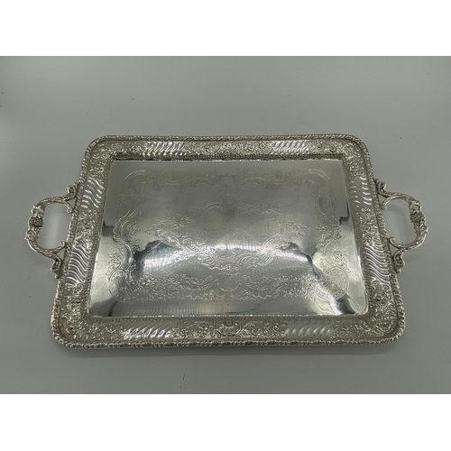 76 - Three silver plated oblong trays with applied loop handles, largest 68 x 41cm