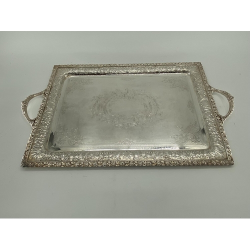 76 - Three silver plated oblong trays with applied loop handles, largest 68 x 41cm