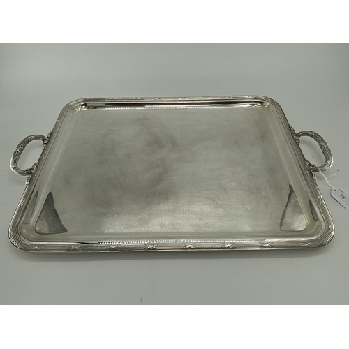 76 - Three silver plated oblong trays with applied loop handles, largest 68 x 41cm