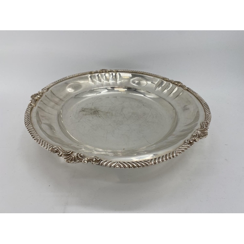 77 - A collection of silver plated items to include a large circular tray, a circular footed tray and oth... 