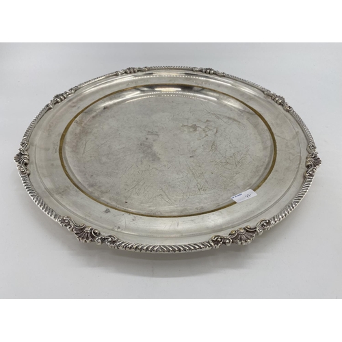 77 - A collection of silver plated items to include a large circular tray, a circular footed tray and oth... 