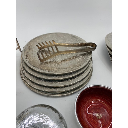 80 - A collection of silver plated items to include coasters, place mats, skewers and other items