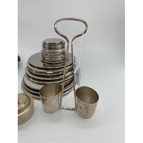 80 - A collection of silver plated items to include coasters, place mats, skewers and other items