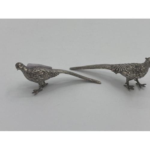 81 - Two Sterling silver topped scent bottles, and 2 white metal table pheasants and a small funnel