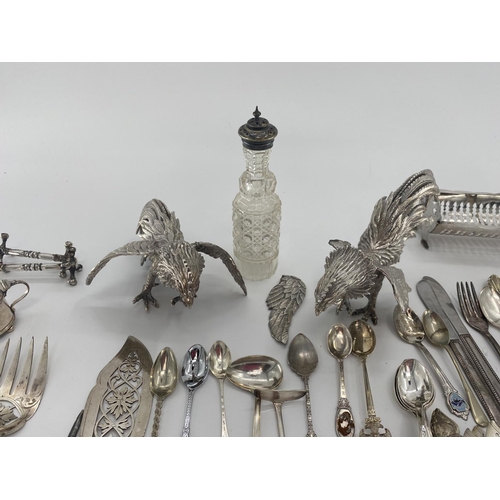 94 - A collection of silver plated and white metal items to include a pair of cast fighting cocks, cutler... 