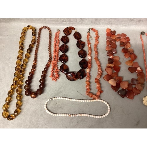 99 - A collection of bead jewellery, to include a dogs tooth corat necklace, carnelian beads and three am... 