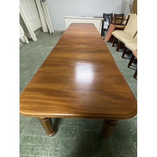 473 - A mahogany square dining table, extending to an oblong metres table, with the extra leaves. Being so... 