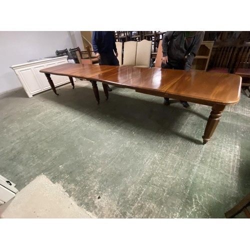 473 - A mahogany square dining table, extending to an oblong metres table, with the extra leaves. Being so... 