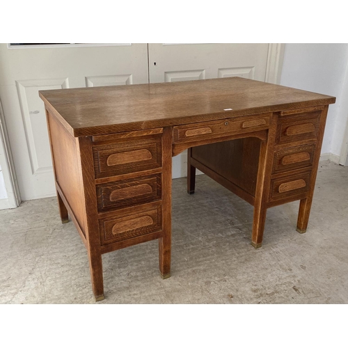 470 - A good early C20th oak desk, single drawer, flanked by slides and three drawers on brass bound feet,... 