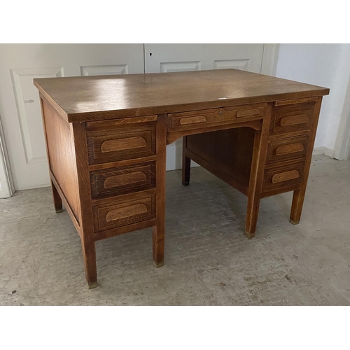 470 - A good early C20th oak desk, single drawer, flanked by slides and three drawers on brass bound feet,... 