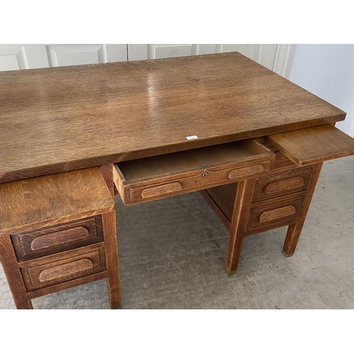 470 - A good early C20th oak desk, single drawer, flanked by slides and three drawers on brass bound feet,... 