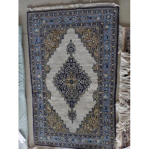 648 - A Qum wool rug, cream and blue ground, 130 x 77cm