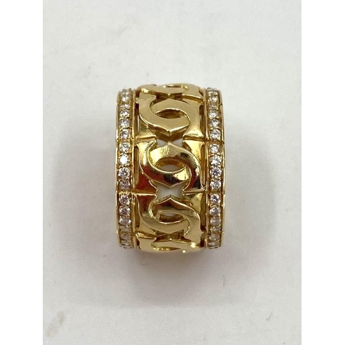 1 - CARTIER an 18k gold  platinum and diamond full eternity ring of pierced design with two lines of sin... 