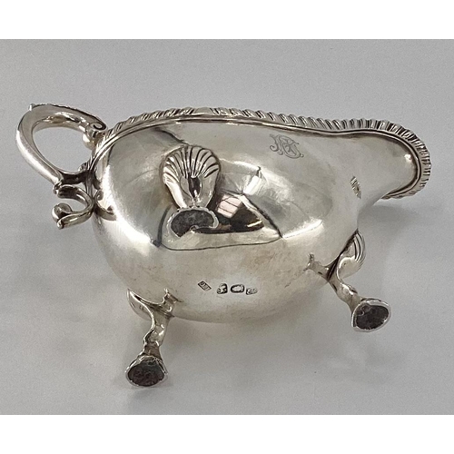 11 - An 18th century sterling silver sauce boat beaded rim, scrolling handle, raised on three feet, by Fr... 