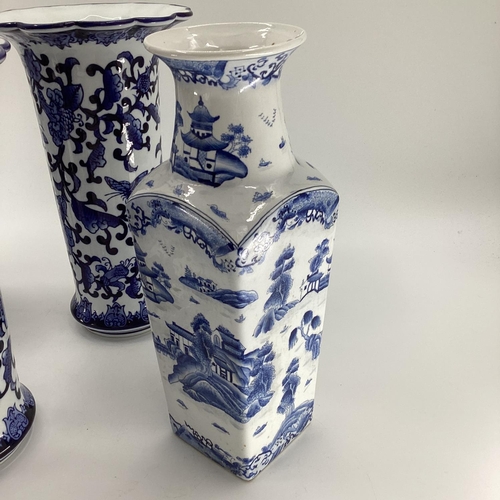 114 - Decorative Modern Blue and White China: a pair of scalloped edge vases, decorated foliage and butter... 