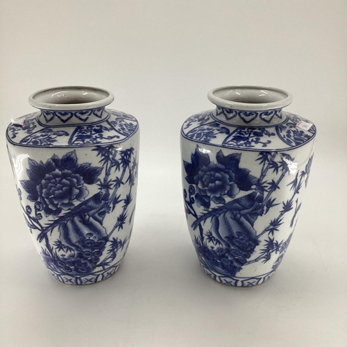 114 - Decorative Modern Blue and White China: a pair of scalloped edge vases, decorated foliage and butter... 