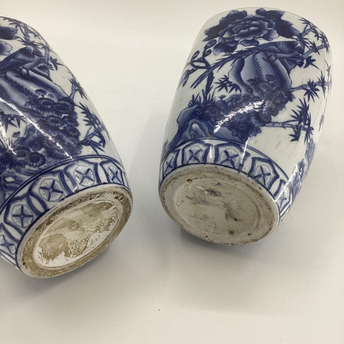 114 - Decorative Modern Blue and White China: a pair of scalloped edge vases, decorated foliage and butter... 