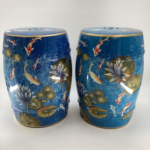 121 - Pair of modern china blue garden seat drums,  in the Chinese taste, decorated water, fish and foliag... 