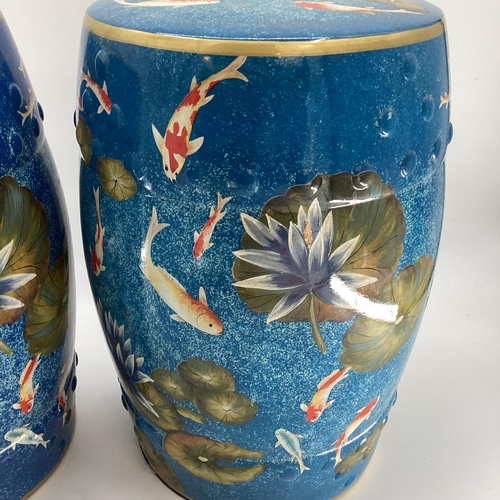 121 - Pair of modern china blue garden seat drums,  in the Chinese taste, decorated water, fish and foliag... 