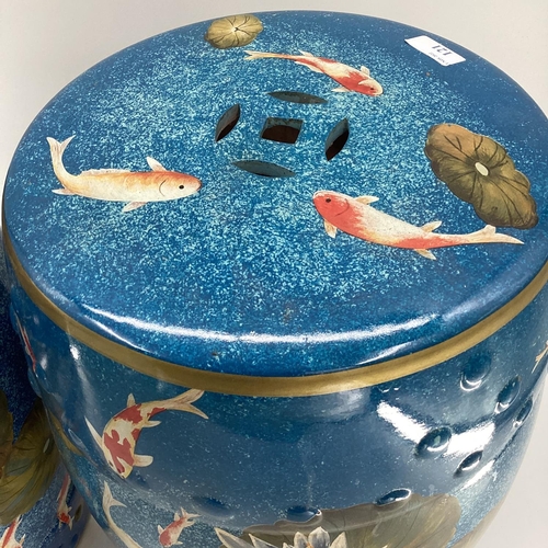 121 - Pair of modern china blue garden seat drums,  in the Chinese taste, decorated water, fish and foliag... 