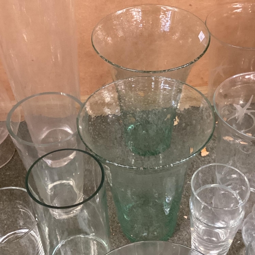 125 - A large quantity of glassware's to include:  candle holders, flower vases,  large bowls, fruit bowls... 