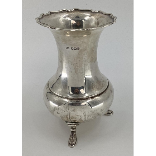 13 - A sterling silver flower vase of bulbous form with flared rim raised on three feet by Atkin Bros She... 