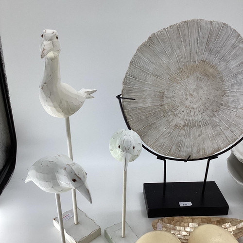 133 - A quantity of decorative items including faux Ostrich eggs, shells, seagull models, fossil type orna... 