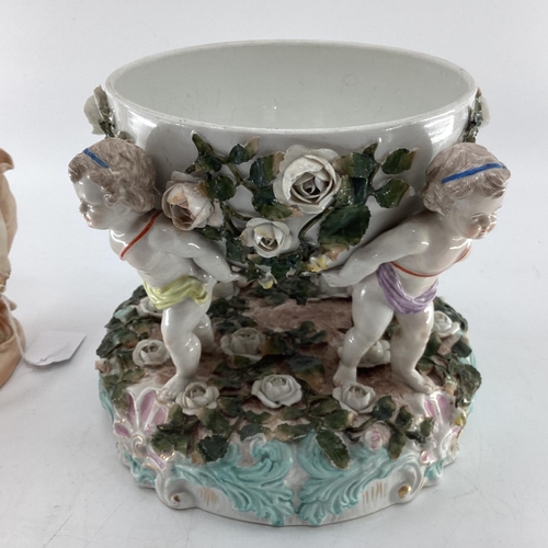 141 - Two items of C20th ceramics, to include a Continental style table centre piece with Putti supports, ... 