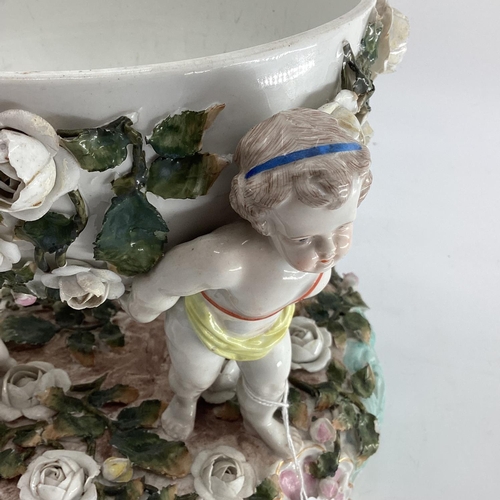 141 - Two items of C20th ceramics, to include a Continental style table centre piece with Putti supports, ... 