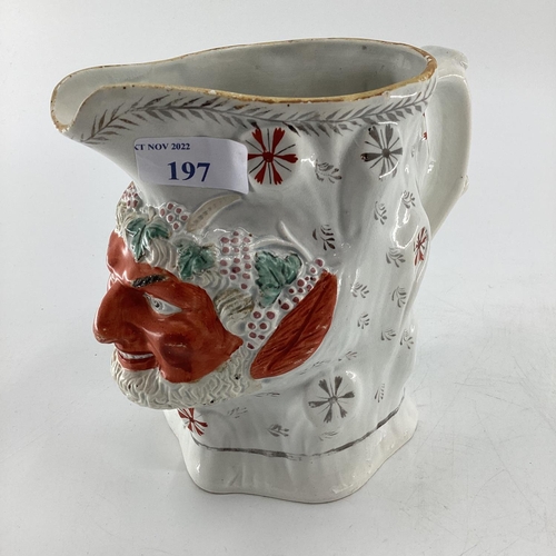 197 - Staffordshire C19th porcelain jug modelled as a satyr, some wear/spout restored possibly