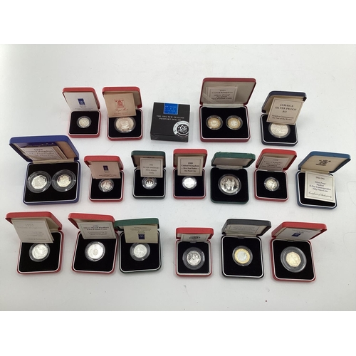 199 - A collection of silver and white metal commemorative  coins. To include silver proof examples.