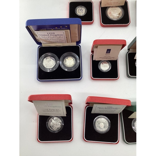 199 - A collection of silver and white metal commemorative  coins. To include silver proof examples.